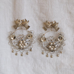 These beautiful Mazahua earrings were created by artisans in central Mexico. Made of silver, they are handcrafted using ancient techniques and feature an intricate, traditional design. 