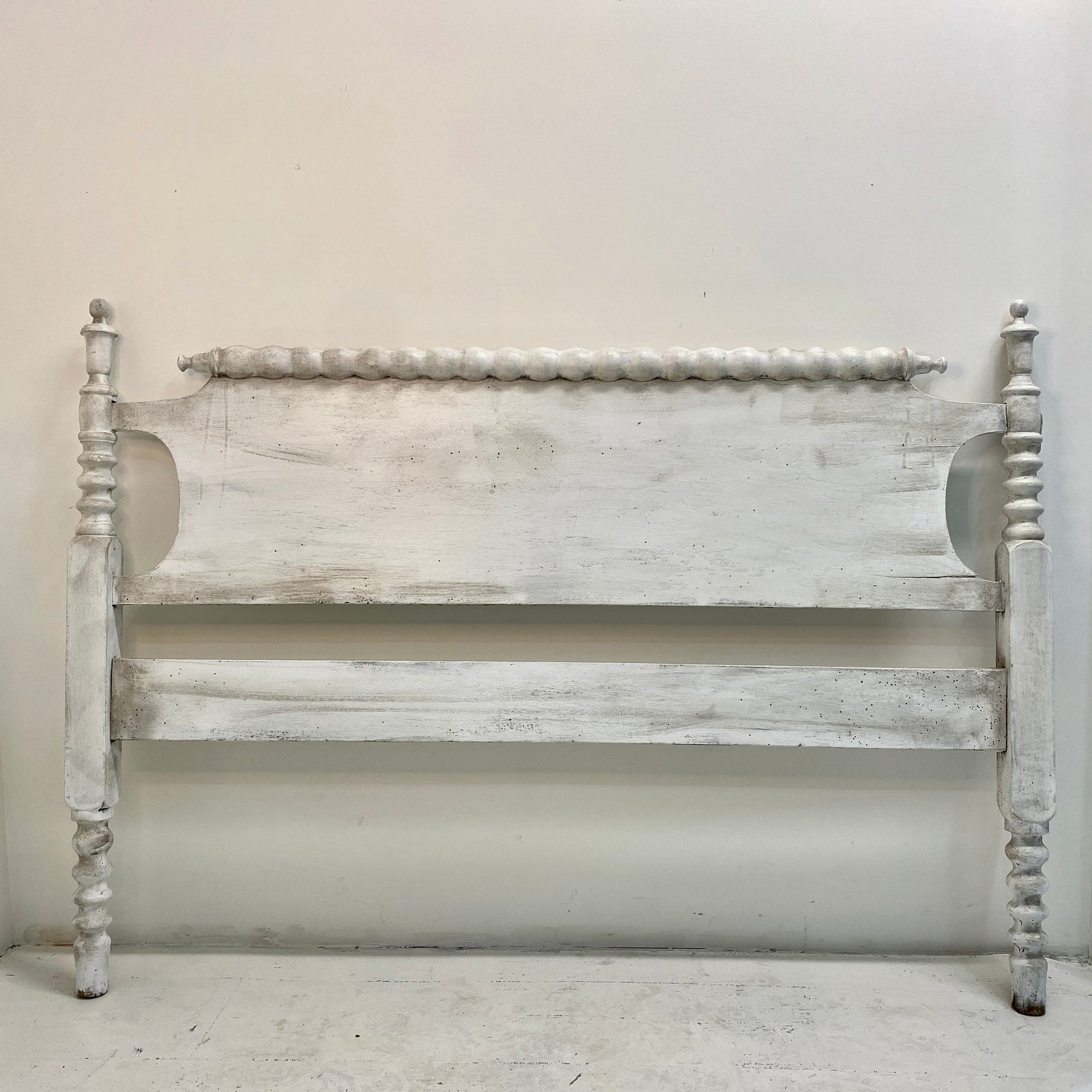 This antique custom-build bedframe evokes the peace and simplicity of country-style decor. Includes a footboard identical to the headboard and matching wooden side rails.   Pick up or local delivery only. Come by the shop to see this one-of-a-kind piece in person!   Dimensions: H 37.5" x W 71.5" x D 50.5". Interior will accommodate a 3/4 sized mattress (between a full and a queen) Wood