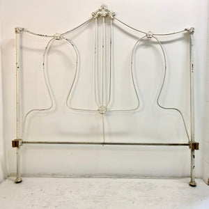 With sweet floral details and a thin but sturdy metal build, this vintage bedframe is both playful and sophisticated. Includes a headboard, footboard, and side rails.  Pick up or local delivery only. Come by the shop to see this one-of-a-kind piece in person!   Dimensions: Headboard: H 54" x W 78.5" x D 53". Footboard:  H 45" x W 78.5" x D 53". Interior will accommodate a full-sized mattress Iron     