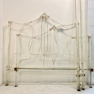 With sweet floral details and a thin but sturdy metal build, this vintage bedframe is both playful and sophisticated. Includes a headboard, footboard, and side rails.  Pick up or local delivery only. Come by the shop to see this one-of-a-kind piece in person!   Dimensions: Headboard: H 54" x W 78.5" x D 53". Footboard:  H 45" x W 78.5" x D 53". Interior will accommodate a full-sized mattress Iron     