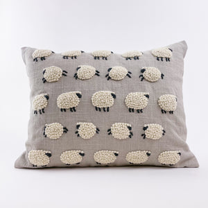 This beautiful pillow with embroidered and applique sheep is perfect for a nursery or child's bedroom. Evocative of Princess Diana's iconic sheep sweater from Rowing Blazers, it could also add a touch of whimsy to any living room.  Material: 100% cotton. Sold with insert. Dry clean only.  Dimensions: 12"x16"