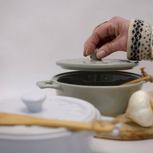 A wonderful Brie Baker, a great gift with a wonderful wood spreader. Available in two colors: white and grey. Dishwasher and oven safe.    7" Round Stoneware